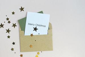 New Year or Christmas top view holiday celebration red envelope letter copy space green color paper background. Template greeting card photo