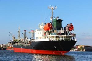 In the evening, cargo ships, oil ships dock at the port. Economy cargo from around the world photo