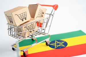 Box with shopping cart logo and Ethiopia flag, Import Export Shopping online or eCommerce finance delivery service store product shipping, trade, supplier concept. photo