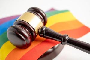 Gavel for judge lawyer on rainbow flag, symbol of LGBT pride month celebrate annual in June social of gay, lesbian, bisexual, transgender, human rights. photo