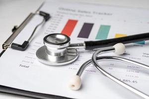 Stethoscope on charts and graphs paper, Finance, Account, Statistics, Investment, Analytic research data economy and Business company concept photo