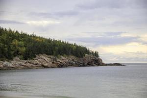 Rocky coastline along the ocean in Maine, United States photo