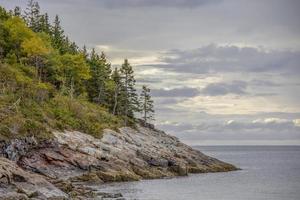 Rocky coastline along the ocean in Maine, United States photo