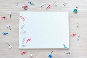 School office supplies on wooden background. Back to school concept. White board with hands for copy space. Top view ready for your design photo