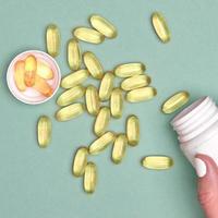 Many transparent pills Omega 3 or fish oil on a colorful background. Health supplements and medicines photo