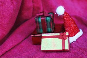 Gift box and christmas decoration with macro close up on red carpet backgrounds photo