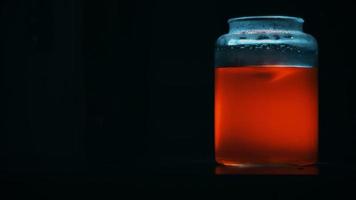 redemoinho de líquido laranja misterioso em uma jarra de vidro video