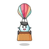 snow ball mascot riding a hot air balloon vector