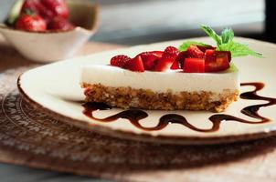 Slice of cheesecake with strawberry, selective focus photo