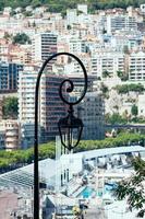 Iron lantern light against Monaco bay on a sunny day photo