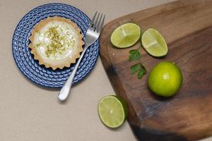 Top view of Tartlet with lemon cream and citrus chips on the old wooden table, Copy space. Selective focus. photo