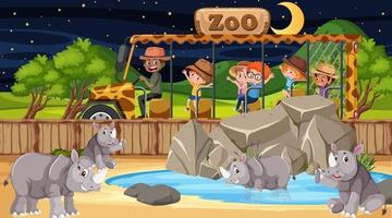 Safari at night scene with many kids watching rhinoceros group vector