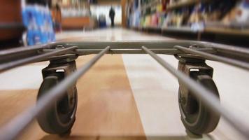 Detail of the Wheels of a Grocery Store Cart Moving inside the Super Market video