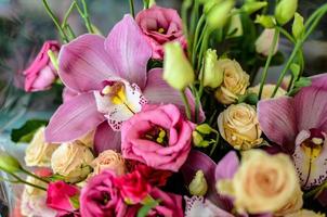 Bouquet with orchids and roses on a beautiful background photo