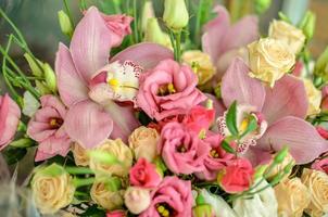 Bouquet with orchids and roses on a beautiful background photo