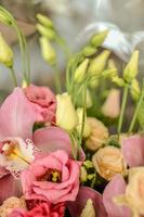 Bouquet with orchids and roses on a beautiful background photo