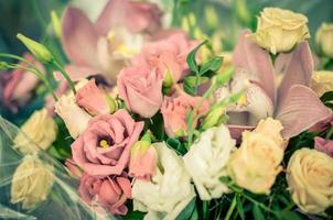 Bouquet with orchids and roses on a beautiful background photo