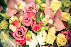 Bouquet with orchids and roses on a beautiful background photo