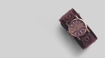 Close view of brown leather man wrist watch on grey background. photo