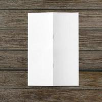 Blank white paper on wooden table. photo