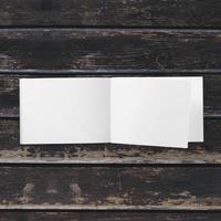 Blank white paper on wooden table photo
