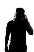 Male in silhouette listening to headphones photo
