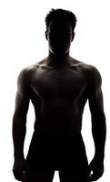 Muscular man in silhouette photo