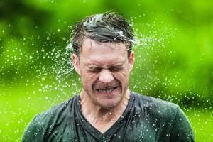 Young Adult Completely Drenched Shaking His head photo