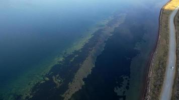 Aerial view with a top view of the clear sea and the road photo