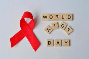 World Aids Day text on wood, isolated at white background photo