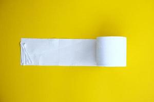 Toilet paper isolated on yellow background and healthcare concept photo