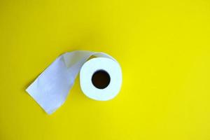 Toilet paper isolated on yellow background and healthcare concept
