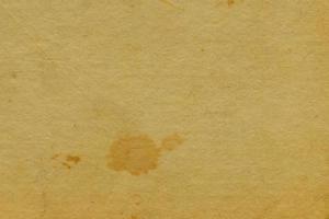 Textura de la superficie del papel del grunge de color amarillo oscuro abstracto y antiguo patrón artístico antiguo de la acuarela en la oscuridad. foto