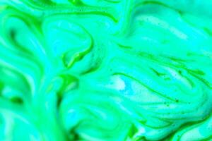 abstract light green beautiful liquid marble fluid acrylic paint vibrant texture on green. photo