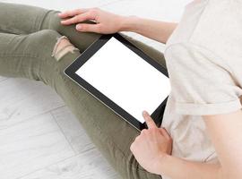 Girl sitting with tablet in hands.Top view.Mock up.Copy space.Template.Blank. photo