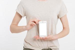 Girl holding white phone. Cellular isolated on white clipping path inside. Top view.Mock up.Copy space.Template.Blank. photo