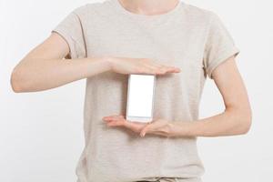 Girl holding white phone. Cellphone isolated on white clipping path inside. Online shopping. Top view.Mock up.Copy space.Template.Blank. photo