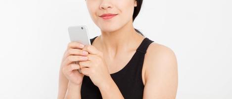 Woman texting. Closeup young happy beautiful asian japanese woman. Girl looking at mobile cellphone isolated on white background. Positive face expression human emotion. Copy space.