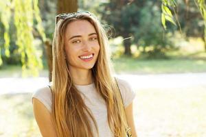 Smile happy Summer woman under a tree in a park close up portrait photo