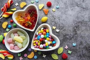 Multicolored candies, dragees and lollipops photo