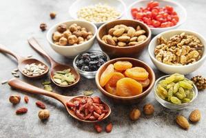 Bowls with various dried fruits and nuts photo
