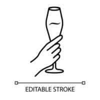 Hand holding tulip wine glass linear icon. Champagne flute. Glassful of alcohol drink. Wine service. Cheers. Thin line illustration. Contour symbol. Vector isolated outline drawing. Editable stroke