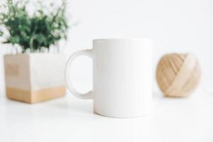white coffee mug with green leaf for mock-up set isolated glassy tankard design on white photo