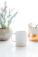 white coffee mug with green leaf for mock-up set isolated glassy tankard design on white photo