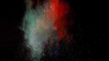 orange and green colorful powder explosion colored cloud dust explode on black photo