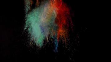 orange and green colorful powder explosion colored cloud dust explode on black photo