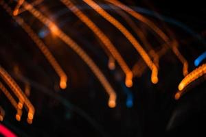 light orange trail blur summer abstract lights at motion swirl trail effect black photo