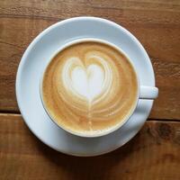 milk coffee with a heart shape from milk in a cup photo