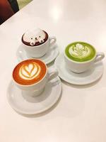 coffee with three different flavors in a cup on the table photo