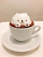 milk coffee with a cute bear-shaped ice cream decoration photo